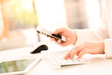 Hands of an office woman typing keyboard with credit card