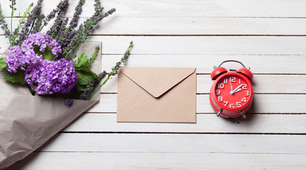 Envelope and wildflowers with alarm clock