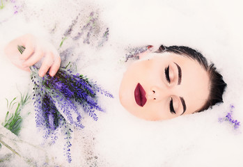 woman with flowers in the foam bath