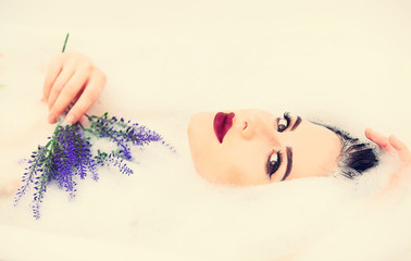 woman with flowers in the foam bath