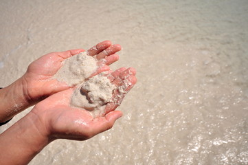 Young woman with sand in hands