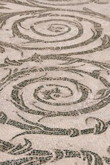 Closeup of Roman mosaic floor detail in an ancient bathhouse