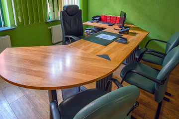 Office with desk and chairs for advising clients