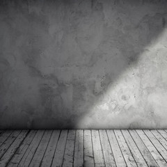 Gray grungy concrete wall and wooden floor