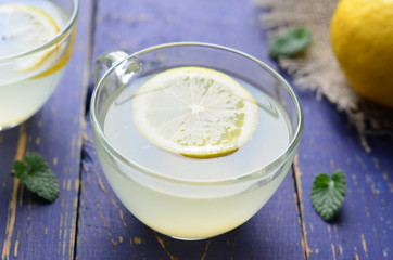 Lemon drink on blue background