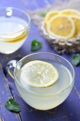 Lemon drink on blue background