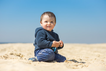 little boy walks on the beach