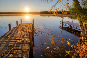Autumn sunrise over dock on Moose lake in northern Wisconsin.