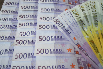 Cash Euro banknotes spread out on the table.