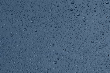 Drops on glass, a grey-blue background