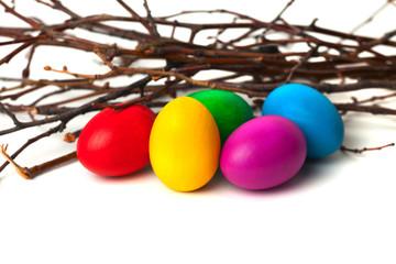 Colored Easter eggs from the branches. On a white background.