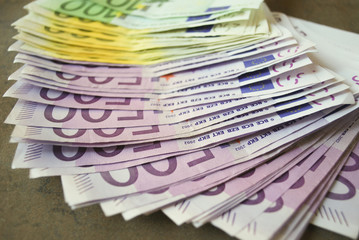 Cash Euro banknotes spread out on the table.