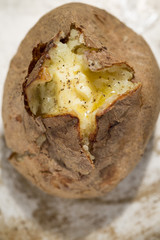 Jacket potato with melted butter and black pepper