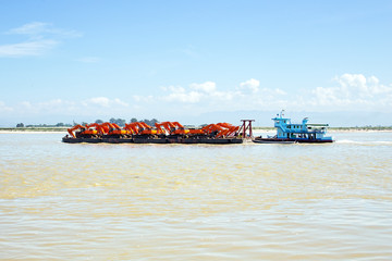 Pusher with cranes on the Ayarwaddi river in Myanmar