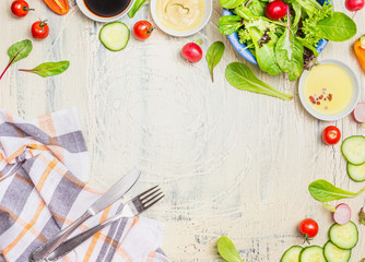 Fresh seasonal organic vegetables salad preparation with dressings ,ingredients cutlery  and...