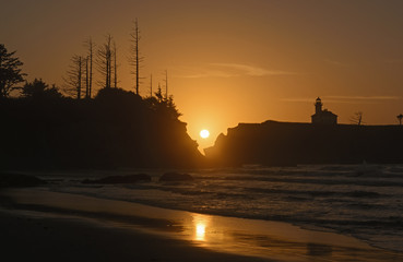 Fototapeta na wymiar Setting Sun Reflections on a Remote Beach