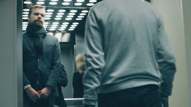businessman in age enters crowded modern office elevator and sneezes, embarrassing others