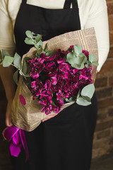 Bouquet of violet alstromeriya in newspaper packing