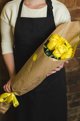 Bouquet of yellow roses in paper wrapping