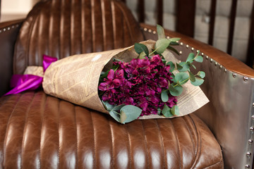 bouquet of violet alstromeriya in newspaper packing