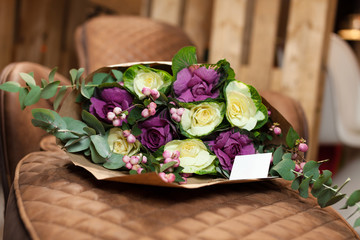 bouquet of violet and yellow roses in paper packing
