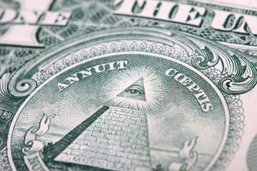 fragment of a dollar bill. eye and pyramid closeup