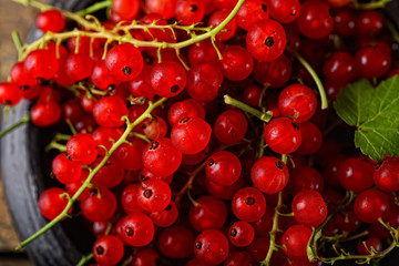 juicy red currants on a wooden background