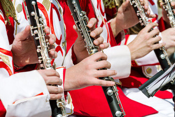 young musicians playing clarinet in street orchestra