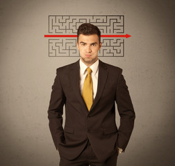 Handsome business guy solving maze