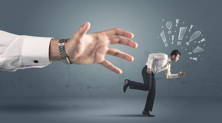 Business person getting away from a big hand