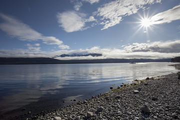 sun light over lake te anau fiordland national park new zealand