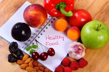 Fruits and vegetables with notebook, slimming and healthy food