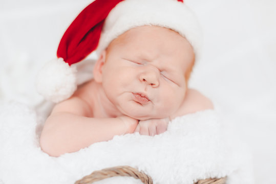 Child sleeps in a hat of Santa Claus