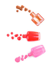 collection of various nail polish bottle and drop on white backg