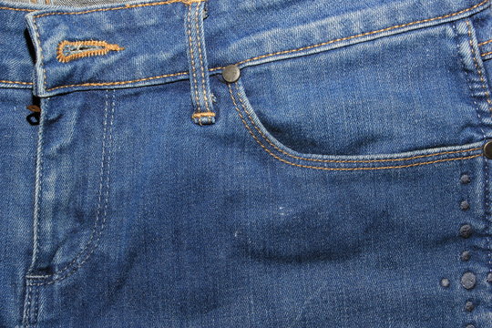 Pocket, zip, buttonholeon blue jeans texture
