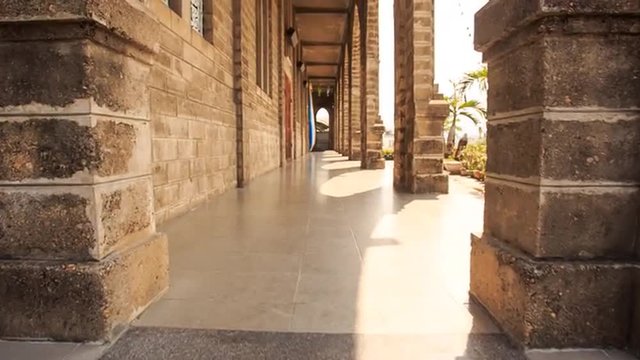 Camera Moves between Wall and Colonnade of Catholic Church