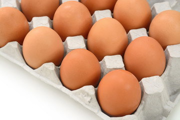 Eggs in paper tray isolated on white