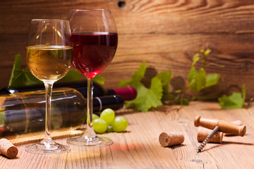 Glasses of red and white wine, served with grapes
