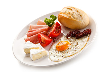 Breakfast - fried egg, bacon, cheese and vegetables 