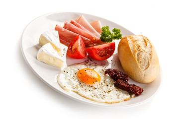 Breakfast - fried egg, bacon, cheese and vegetables 