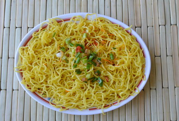 Chinese noodle topping chop spring onion on dish