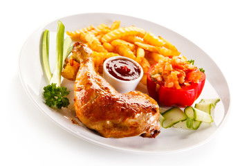 Grilled chicken legs with chips and vegetables 