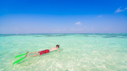 Maldives, man snorkeling