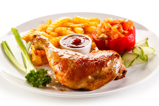 Grilled chicken legs with chips and vegetables 