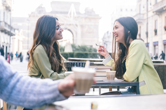 Two Friends Having A Coffee In The City Center