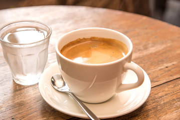 Coffee,White Coffee Mug,Glass water,Wooden table.