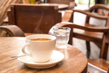 Coffee,White Coffee Mug,Glass water,Wooden table.