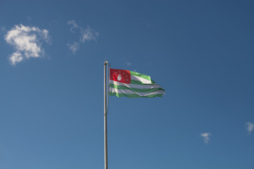 The flag of Abkhazia on the background of blue sky