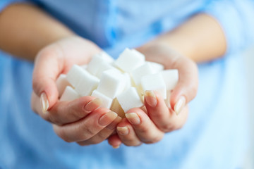 Woman with cubes of white sugar