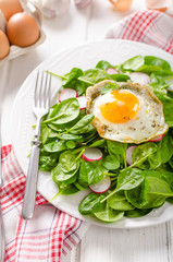 Fresh spinach, radish salad with fried egg